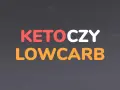 Napis KETO CZY LOW CARB w kolorach czerwonym, białym i pomarańczowym na ciemnym tle.